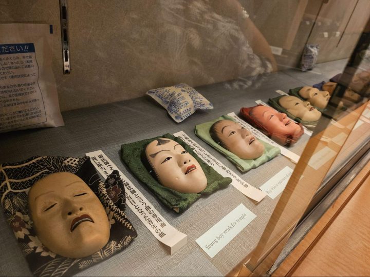 A display of historic Noh masks at the Kamakura Noh Theatre