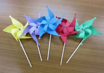 Image of A pinwheel with the Children's Land logo